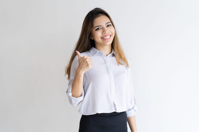 Photo of happy girl giving the thumbs up illustrates blog "5 Common Job Interview Questions and How to Answer Them"