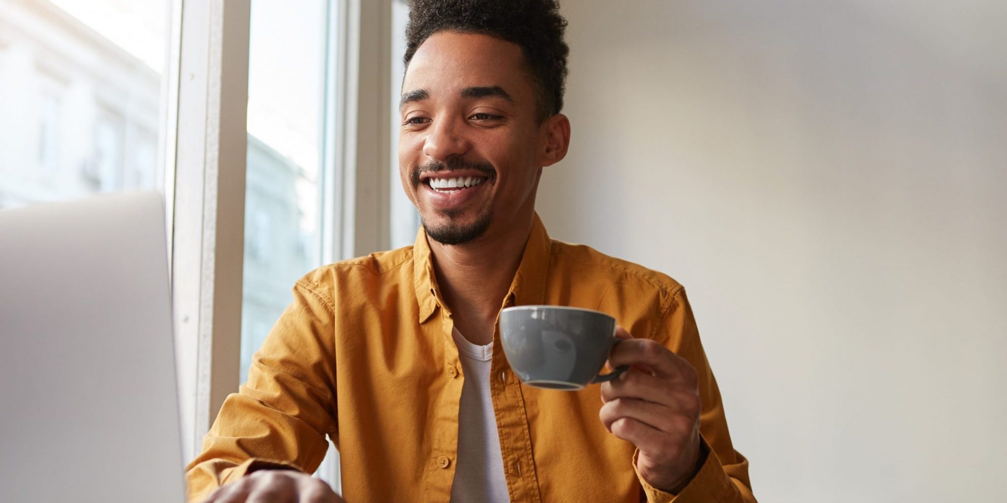 Photo of man sitting at a computer illustrates blog: "Job Seeker Tips: 4 Things to Do Before Starting Your Job Search"