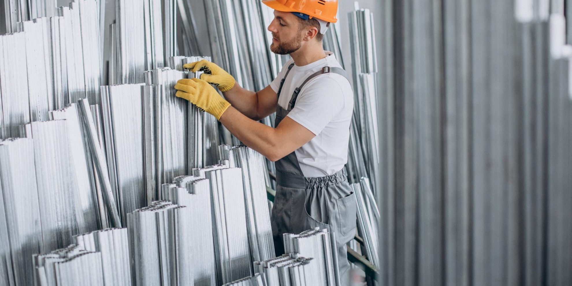 Photo of man with hard hat and gloves illustrates blog:: "Manufacturing Jobs in California: What You Need to Know"