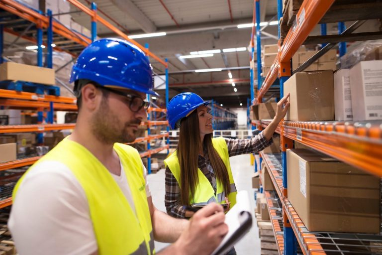 Photo of man and woman working in warehouse illustrates blog "10 Common Warehouse Jobs and Their Responsibilities"